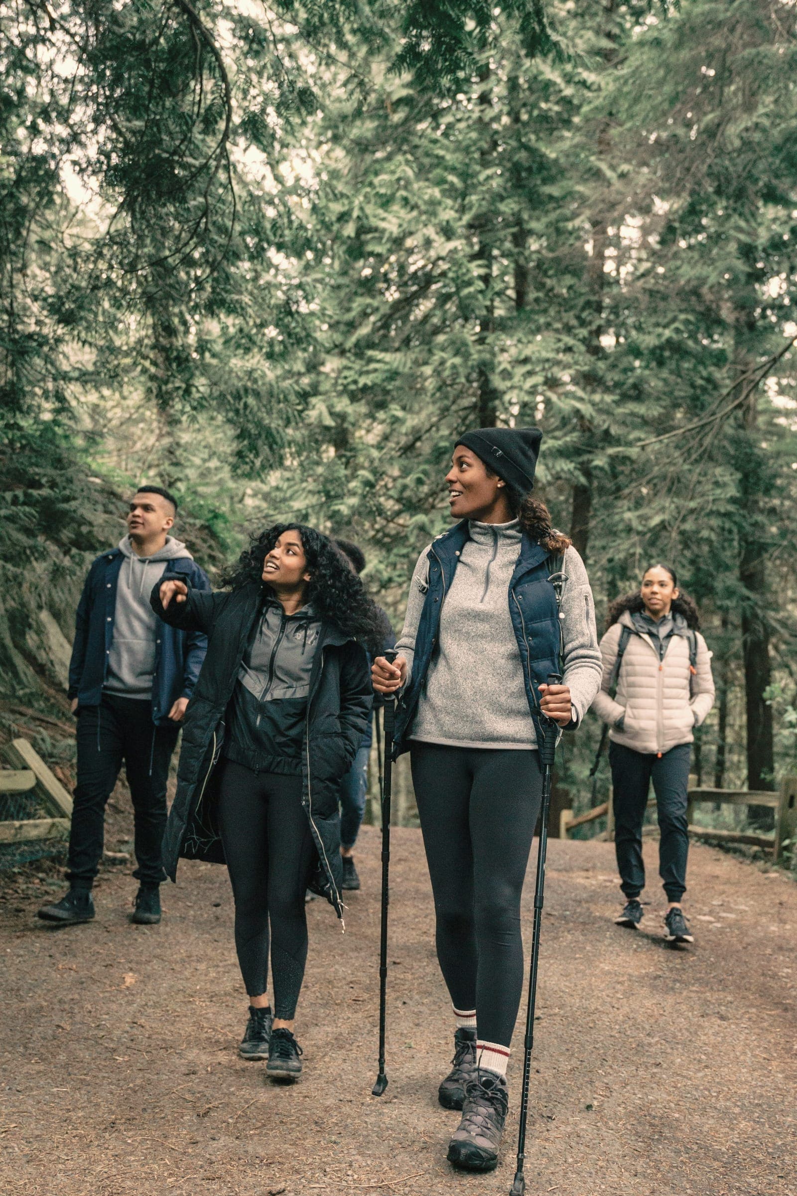 A small group walking through an autumn forest