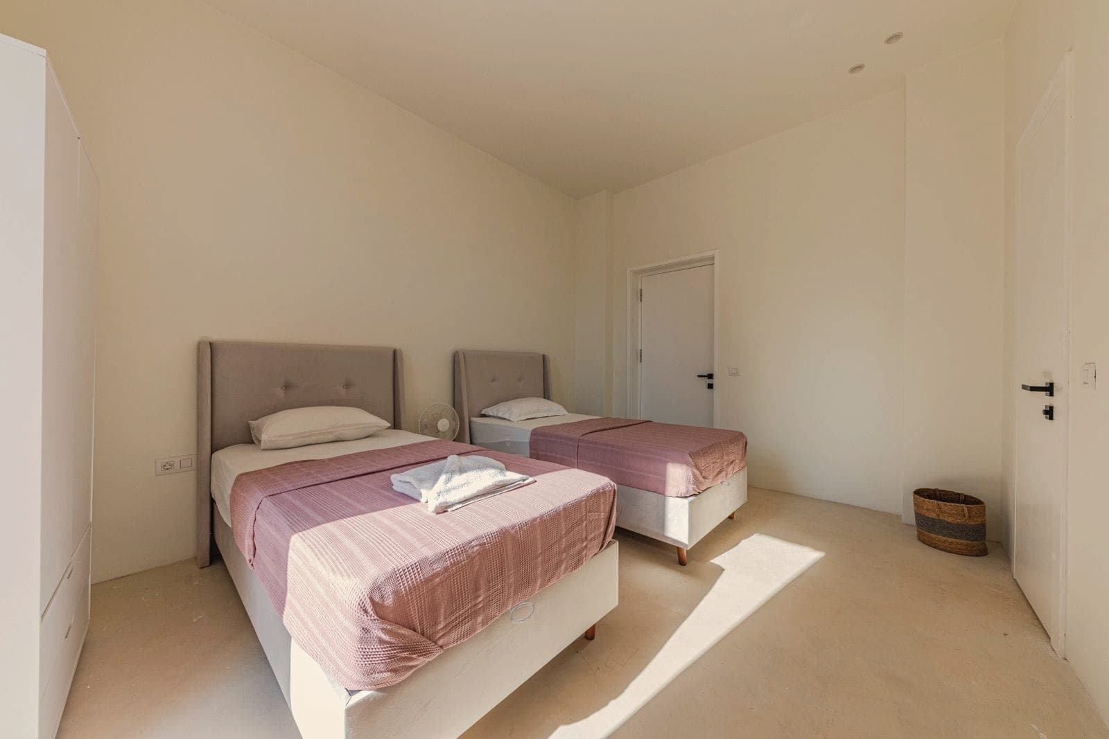 A bright room with two single beds